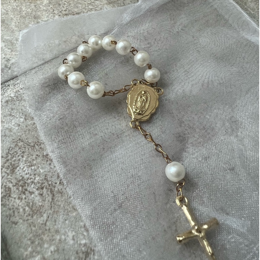 Miniature rosary beads with cross.